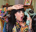 Relieved woman in paisley on rotary telephone