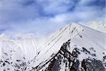 Off-piste slope in morning and sky with clouds. Caucasus Mountains, Georgia, ski resort Gudauri.