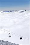 Ski slope, chair-lift and mountains under clouds. Caucasus Mountains, Georgia. Ski resort  Gudauri.