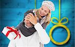 Happy winter couple with gift against blurred christmas background