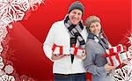 Festive mature couple holding christmas gifts against christmas themed snow flake frame