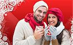 Winter couple holding mugs against christmas themed snow flake frame