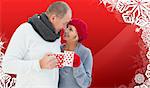 Mature couple holding mugs against christmas themed snow flake frame