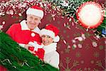 Festive mature couple holding gift against snowflake wallpaper pattern