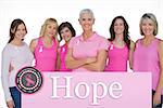 Enthusiastic women posing with pink tops for breast cancer against pink card