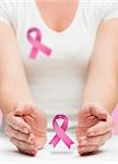 Woman presenting breast cancer awareness message in her hands