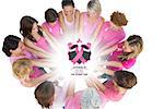 Cheerful women joined in a circle wearing pink for breast cancer against breast cancer awareness message