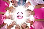Cheerful women in circle wearing pink for breast cancer against breast cancer awareness message