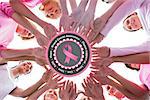 Happy women in circle wearing pink for breast cancer against breast cancer awareness message in pink