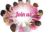 Cheerful women joined in a circle wearing pink for breast cancer on white background