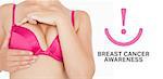 Closeup of woman performing self breast examination against breast cancer awareness message