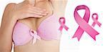 Woman in bra with breast cancer awareness ribbon against pink breast cancer awareness ribbons