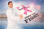 Doctor with breast cancer awareness message for awareness month