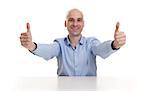 Smiling young business man thumbs up. isolated over white