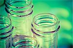 closeup of test tubes with red liquid in laboratory on green and yellow light tint background