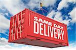 Same Day Delivery - Red Hanging Cargo Container on Sky Background.