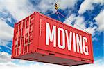 Moving - Red Hanging Cargo Container on Sky Background.