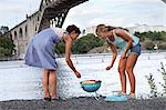 Mother and daughter grilling at river