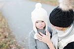 Mother with daughter on walk at autumn