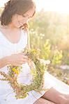 Young woman making flower wreath