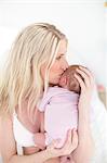 Woman holding newborn daughter