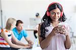 Portrait of woman listening music on cell phone