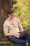 Young man using laptop outdoor