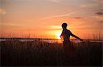 Silhouette of woman at sunset