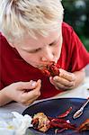 Boy eating crayfish