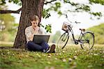 Young man using laptop outdoor
