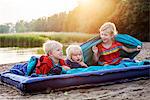 Children on inflatable matress on beach