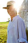 Mature woman wearing sun hat looking at camera