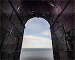 Sea seen through stone arch