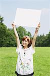 Japanese woman with white board in a park