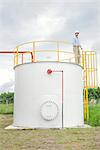 Engineer inspecting chemical storage tank