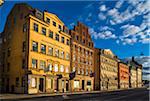 Sunlight reflected on buildings on city street, Gamla stan (Old Town), Stockholm, Sweden