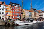 Historical, wooden sailing ship docked at waterfront, Nyhavn Harbour, Copenhagen, Denmark