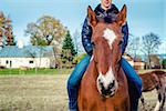 Man riding on a brown horse