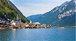 Hallstatt, Austria - August 7, 2013: Panoramic view of Hallstatt village with traditional boat on lake, Hallstatt, Austria