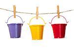 Three buckets hanging on the rope isolated on white background