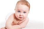 Cute baby girl with big blue eyes lying with diaper isolated on white background.