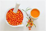Sea buckthorn juice, juice and berries isolated on white background. Natural detox.