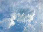 Soft white clouds against blue sky .