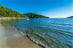 Sandy beach with clear water waves - Saplunara, Mljet Island - Croatia.