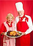 Senior couple works together to prepare a delicious holiday meal.