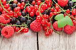 Fresh ripe berries on wooden table background