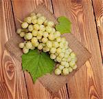 Bunch of white grapes on wooden table background