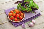 Fresh farmers tomatoes and basil on wood table