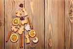 Christmas fir tree made from food decoration spices and gingerbread cookies on wooden table. View from above with copy space