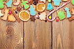Christmas wooden background with spices, gingerbread cookies and copy space